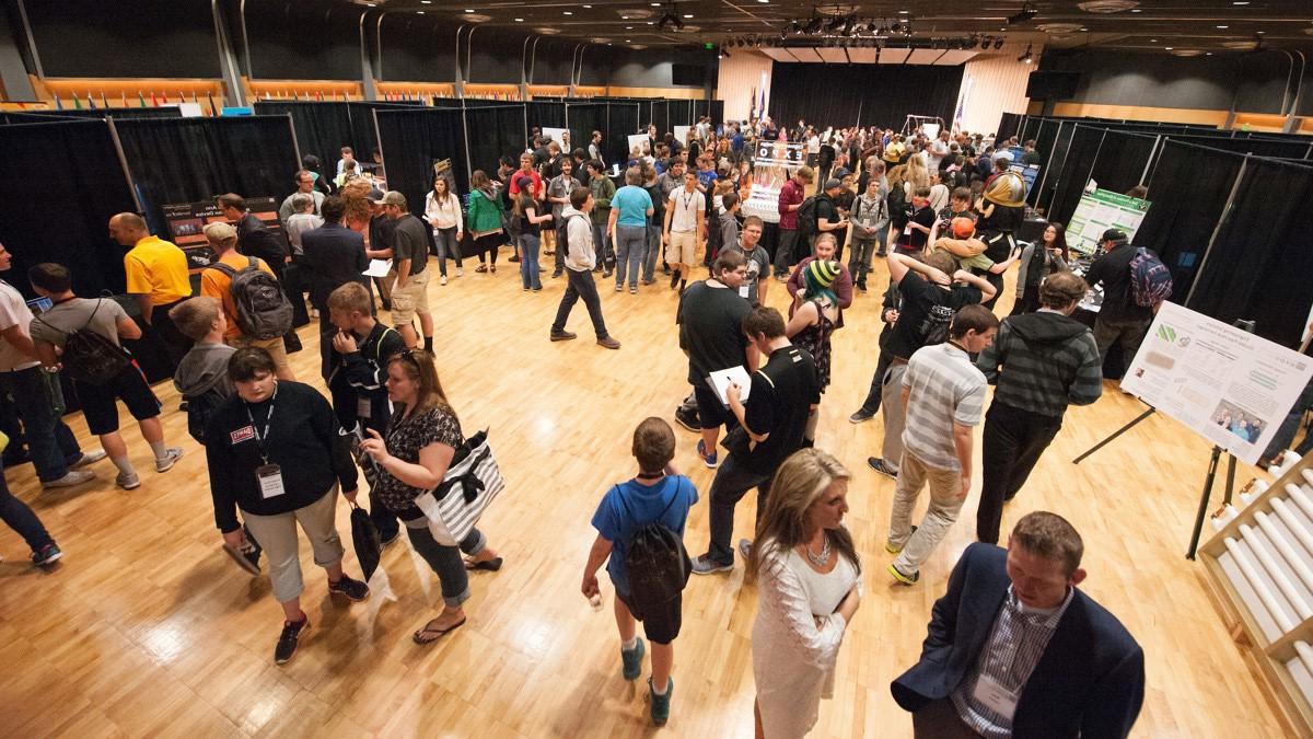 Visitors examine exhibits during an expo held in the International Ballroom